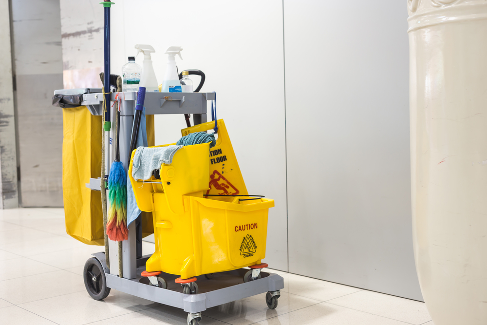 Yellow mop bucket and set of cleaning equipment